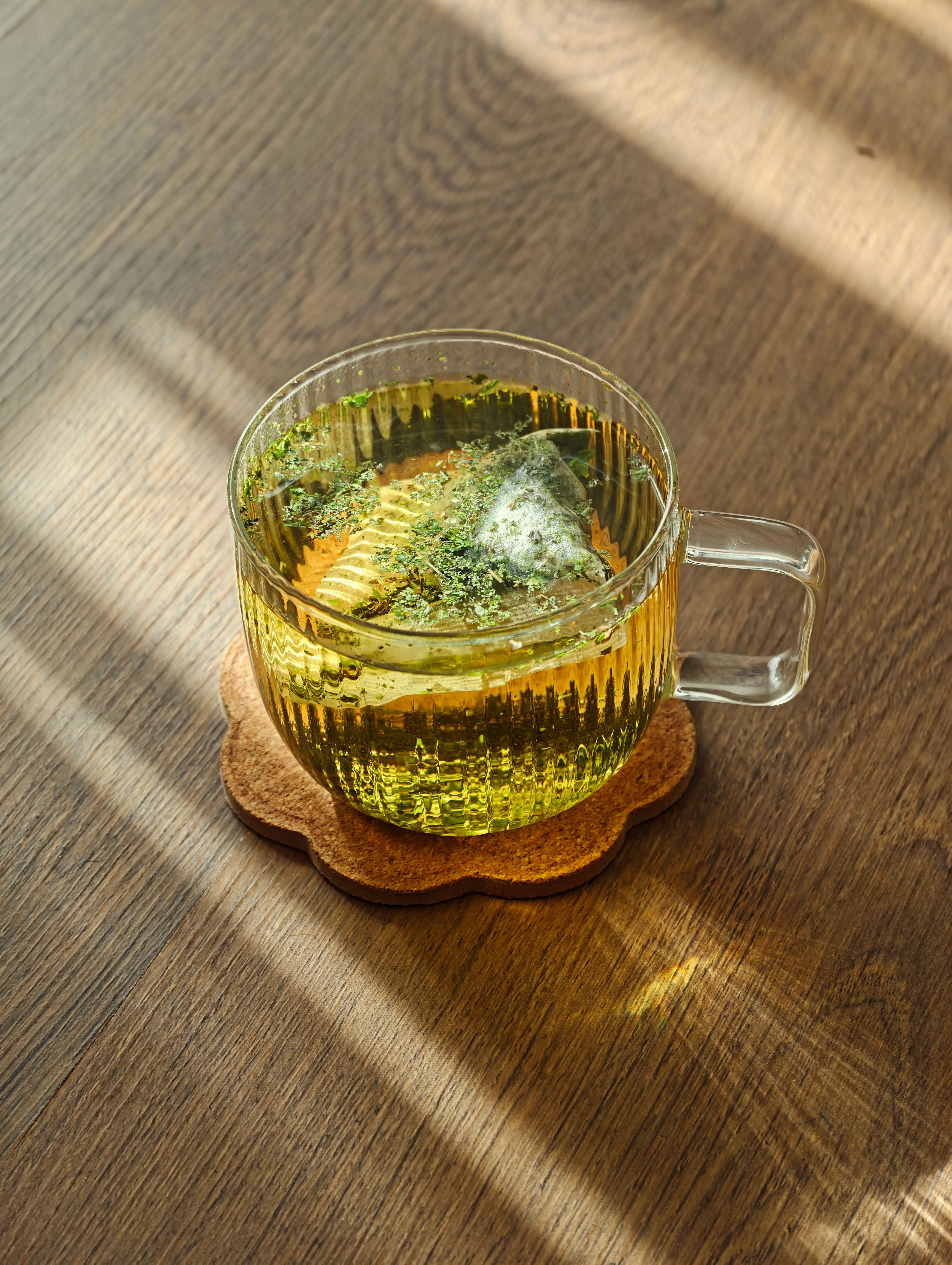 Green tea toner for acne prone skin — glass cup of green tea in warm natural light