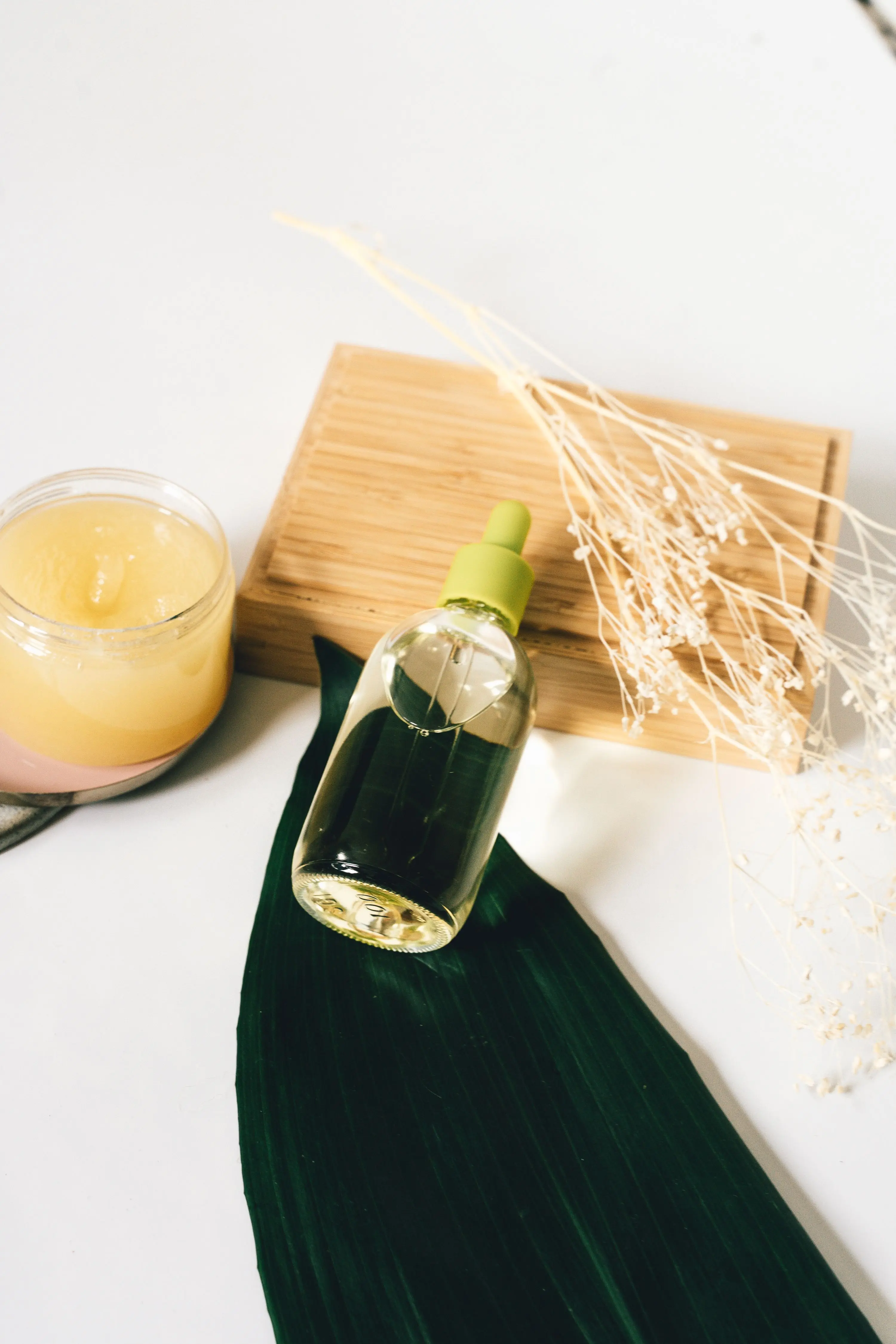 Natural DIY skincare toner storage — glass dropper bottle aloe jar botanical ingredients