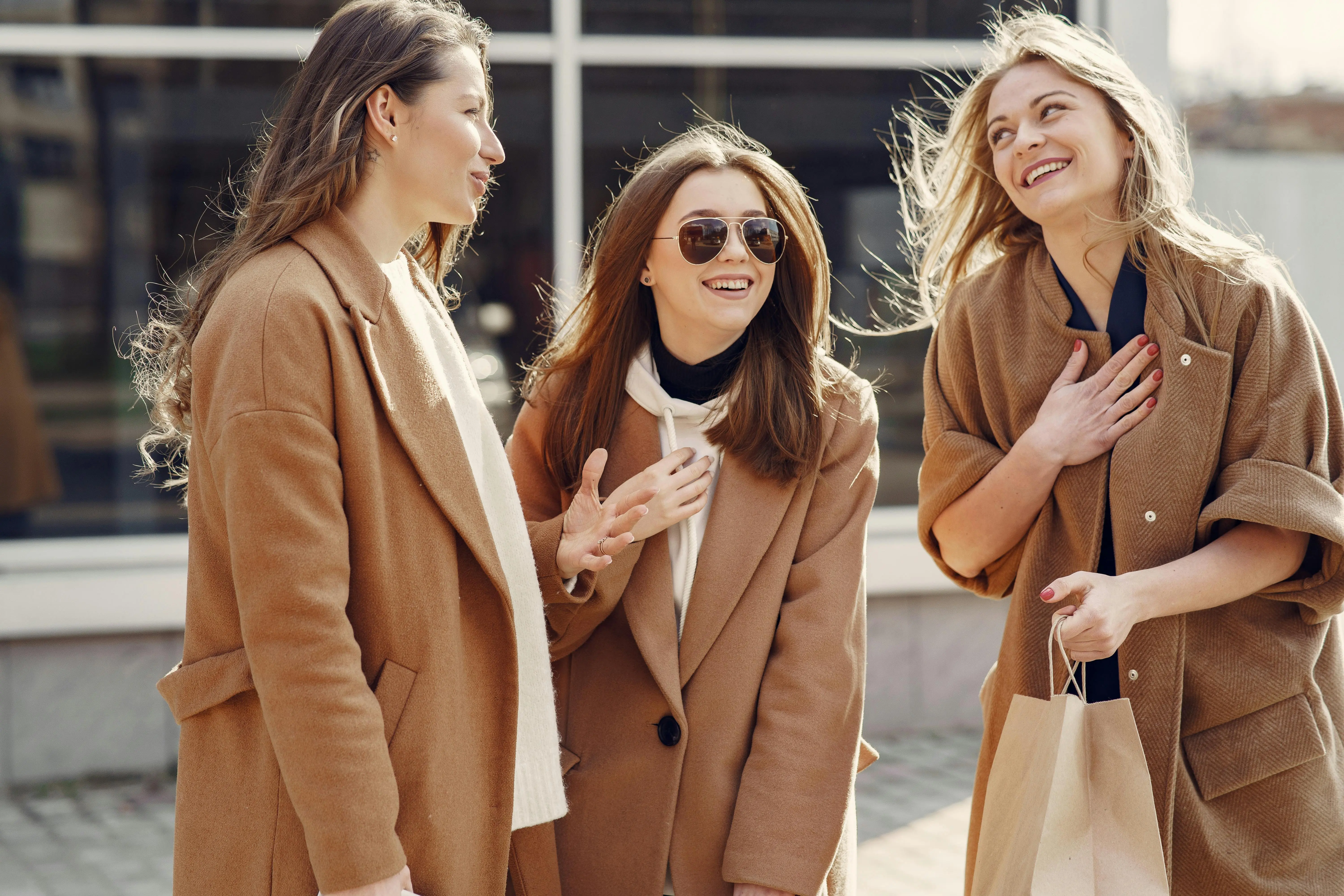 Quiet luxury capsule wardrobe 2026 — women wearing camel coats and neutral tones street style